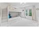 Bright bedroom with a white bunk bed featuring built-in stairs and drawer storage at 5310 Addington Ct, Charlotte, NC 28277