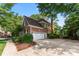 A view of the brick home's side reveals a convenient garage and a well-maintained, landscaped yard at 5310 Addington Ct, Charlotte, NC 28277