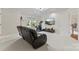 Well-lit living room with a ceiling fan, large TV, and a comfortable leather sofa at 5310 Addington Ct, Charlotte, NC 28277