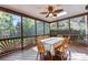 Relaxing screened porch with wood table, wicker fan, and view of backyard at 5310 Addington Ct, Charlotte, NC 28277
