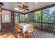 Relaxing screened porch with wood table, brick, wicker fan, and view of backyard at 5310 Addington Ct, Charlotte, NC 28277