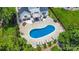 Aerial view of the backyard highlighting the pool, patio with dining, and lounge seating at 5723 Lindley Crescent Dr, Indian Trail, NC 28079