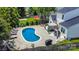 Aerial view of the backyard featuring a large pool, lounge chairs, patio, and lush landscaping at 5723 Lindley Crescent Dr, Indian Trail, NC 28079