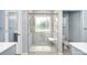 Renovated bathroom with a glass shower featuring a built-in seat and a window at 5723 Lindley Crescent Dr, Indian Trail, NC 28079