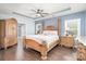 Spacious bedroom featuring a decorative tray ceiling, ceiling fan, and luxurious wood furniture at 5723 Lindley Crescent Dr, Indian Trail, NC 28079