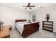 Well-lit bedroom with a ceiling fan, window, and classic wood furnishings at 5723 Lindley Crescent Dr, Indian Trail, NC 28079