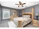 Well-lit bedroom featuring a neutral palette, ceiling fan, and comfortable furniture at 5723 Lindley Crescent Dr, Indian Trail, NC 28079