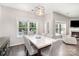 Bright dining room featuring modern light fixture and backyard views of the pool at 5723 Lindley Crescent Dr, Indian Trail, NC 28079