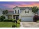 Charming two-story home featuring manicured lawn, stone accents, and attached two car garage at 5723 Lindley Crescent Dr, Indian Trail, NC 28079