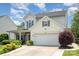 This two-story home boasts beautiful landscaping, a two-car garage, and a covered porch at 5723 Lindley Crescent Dr, Indian Trail, NC 28079