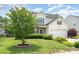 Charming two-story home with well-manicured lawn, complemented by a tree at 5723 Lindley Crescent Dr, Indian Trail, NC 28079