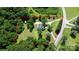 Aerial view of a home surrounded by lush trees and an expansive yard, with a driveway at 604 Ferguson Ridge Rd, Gastonia, NC 28052