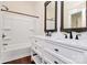 Bright bathroom featuring a double vanity with white cabinetry and a shower over tub at 604 Ferguson Ridge Rd, Gastonia, NC 28052