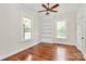 Bright bedroom features hardwood floors, built-in shelving, and two windows for ample natural light at 604 Ferguson Ridge Rd, Gastonia, NC 28052