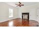 Bedroom with hardwood floors features a decorative fireplace and plenty of natural light at 604 Ferguson Ridge Rd, Gastonia, NC 28052