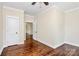 Hardwood floors and white trim detail this bedroom with paneled ceiling and neutral walls at 604 Ferguson Ridge Rd, Gastonia, NC 28052