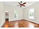 Bedroom with hardwood floors, beadboard wainscoting, two windows, and access to the bathroom at 604 Ferguson Ridge Rd, Gastonia, NC 28052