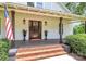 Inviting front porch with brick steps, wooden columns, and a classic wood front door at 604 Ferguson Ridge Rd, Gastonia, NC 28052