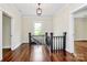 Upstairs hallway with hardwood floors and dark wood railing creates a classic look at 604 Ferguson Ridge Rd, Gastonia, NC 28052