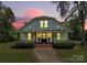 Charming home exterior with front porch, walkway, and manicured landscaping at sunset at 604 Ferguson Ridge Rd, Gastonia, NC 28052