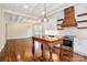 Open kitchen with white cabinets, stainless appliances, a center island, and hardwood floors connected to living room at 604 Ferguson Ridge Rd, Gastonia, NC 28052