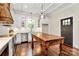 Bright kitchen with white cabinets, a wooden island, modern stainless-steel appliances, and a decorative range hood at 604 Ferguson Ridge Rd, Gastonia, NC 28052
