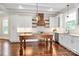 Bright kitchen features white cabinets, stainless appliances, a center island, and stylish wood range hood at 604 Ferguson Ridge Rd, Gastonia, NC 28052