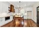 Bright kitchen features white cabinets, stainless appliances, a center island, and stylish wood range hood at 604 Ferguson Ridge Rd, Gastonia, NC 28052