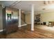 Basement features a stainless steel refrigerator, wood look floors, and a partially finished area at 613 E Ridge St, Kings Mountain, NC 28086