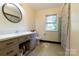 Bathroom featuring updated vanity, tile flooring, and shower with curtain, providing a functional space at 613 E Ridge St, Kings Mountain, NC 28086