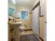 Cozy bathroom with a pedestal sink, yellow tiled walls, and vintage accents, offering a retro charm at 613 E Ridge St, Kings Mountain, NC 28086