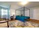 Bedroom showcasing a four-poster bed, light blue walls, and hardwood floors for a relaxing retreat at 613 E Ridge St, Kings Mountain, NC 28086