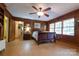 Spacious bedroom with wood paneling, ceiling fan, and abundant natural light from the windows at 613 E Ridge St, Kings Mountain, NC 28086