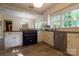 Updated kitchen features white cabinets, stainless steel appliances, a blue oven, and a bright, airy atmosphere at 613 E Ridge St, Kings Mountain, NC 28086
