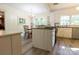 Updated kitchen features white cabinets, stainless steel appliances, and a cozy dining area at 613 E Ridge St, Kings Mountain, NC 28086