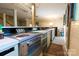 Functional kitchenette with stainless steel oven and cooktop with ample cabinet space in finished basement at 613 E Ridge St, Kings Mountain, NC 28086