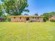 Expansive backyard with a well-maintained lawn, mature trees, and a view of the back of the brick home at 6416 Wilgrove Mint Hill Rd, Mint Hill, NC 28227