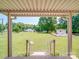Scenic backyard view featuring a sprawling lawn, mature trees, an outbuilding, and steps at 6416 Wilgrove Mint Hill Rd, Mint Hill, NC 28227