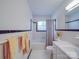 Traditional white bathroom with tiled walls, a bathtub, and a window for natural light at 6416 Wilgrove Mint Hill Rd, Mint Hill, NC 28227