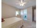 Well-lit bedroom includes a bed, ceiling fan, and view into an adjacent bathroom at 6416 Wilgrove Mint Hill Rd, Mint Hill, NC 28227