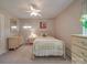 Bright bedroom showing decor, a window view, and neutral-toned walls and carpet at 6416 Wilgrove Mint Hill Rd, Mint Hill, NC 28227