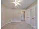 Neutral bedroom with ceiling fan, carpet flooring and standard double door closet at 6416 Wilgrove Mint Hill Rd, Mint Hill, NC 28227