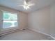 Bright bedroom with a ceiling fan and neutral carpet at 6416 Wilgrove Mint Hill Rd, Mint Hill, NC 28227