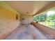 Spacious carport attached to a brick home, with a door leading to the backyard at 6416 Wilgrove Mint Hill Rd, Mint Hill, NC 28227