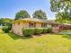 Well-maintained brick home featuring red shutters, lush landscaping, and a green lawn at 6416 Wilgrove Mint Hill Rd, Mint Hill, NC 28227