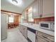 Kitchen area with white cabinets, appliances, and an adjacent dining space at 6416 Wilgrove Mint Hill Rd, Mint Hill, NC 28227