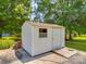 Outdoor shed with a window, door, ramp, and brick trim at 6416 Wilgrove Mint Hill Rd, Mint Hill, NC 28227