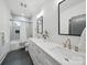 Bright bathroom features dual sinks, modern fixtures, soaking tub, and gray tiled shower at 708 Cross Trail Dr, Charlotte, NC 28204