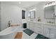 Elegant bathroom featuring a standalone tub, modern fixtures, and vanity with ample counter space at 708 Cross Trail Dr, Charlotte, NC 28204