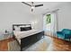Primary bedroom with hardwood floors, ceiling fan, accent chair, large rug and natural light at 708 Cross Trail Dr, Charlotte, NC 28204